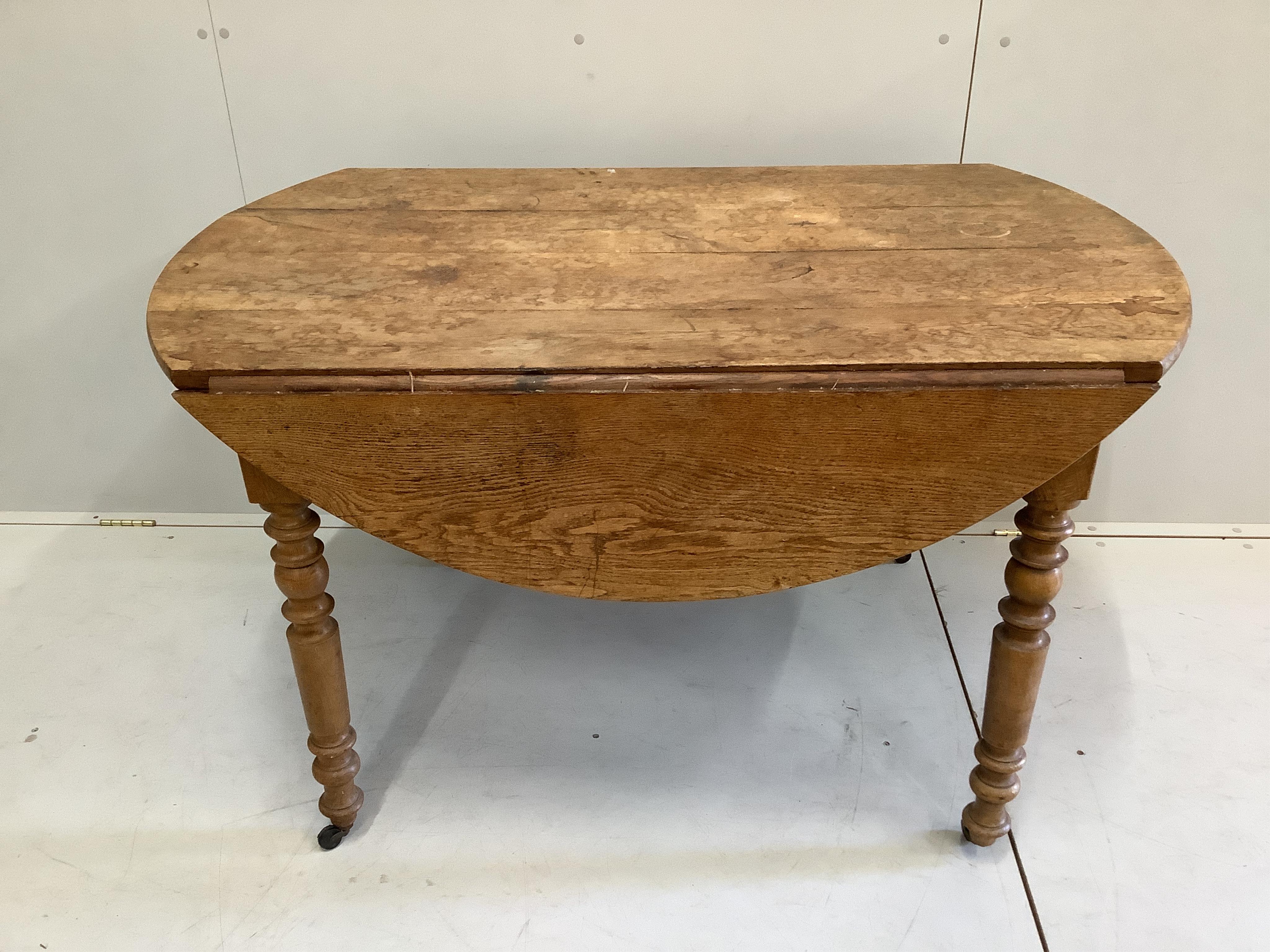 A 19th century French oak drop flap dining table, width 124cm, depth 76cm, height 73cm